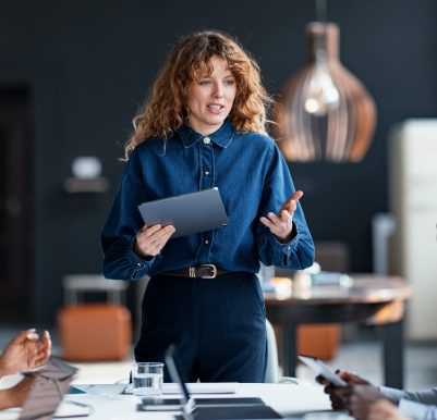 Businesswoman speaking at conference table